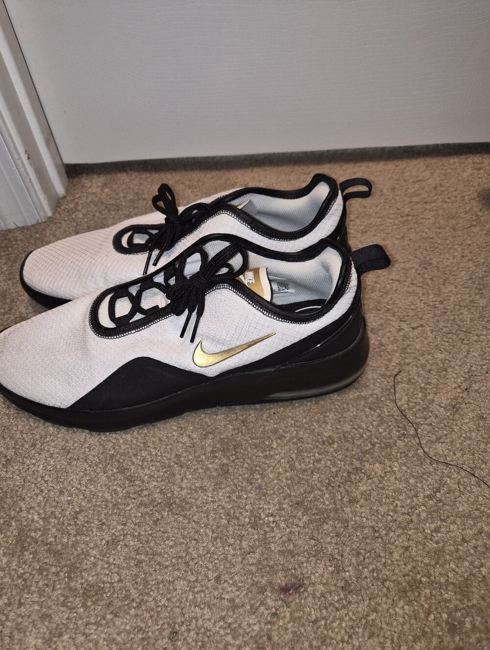 Nike White and Black Slip-On Sneakers with Gold Swoosh